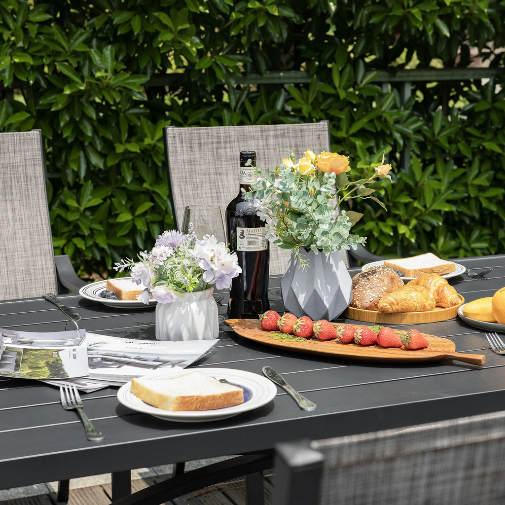 Nouveauté 2026 – Ensemble de salle à manger d'extérieur 7 pièces Nuu Garden , en aluminium résistant à la rouille, comprenant 6 chaises en textilène et une table rectangulaire avec trou pour parasol, couleur brun grisâtre